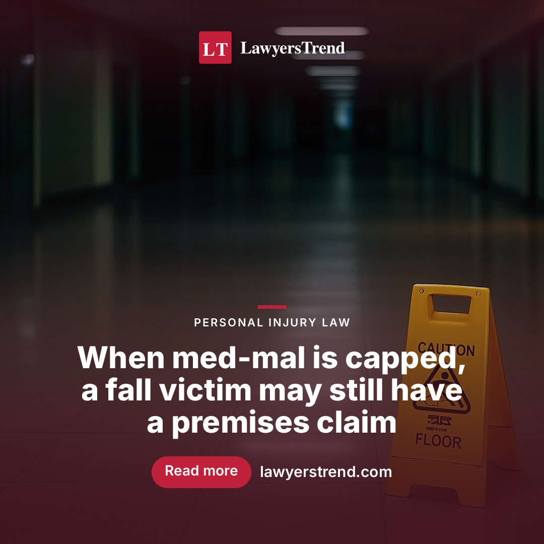 Long hospital corridor with polished floor and fluorescent overhead lighting